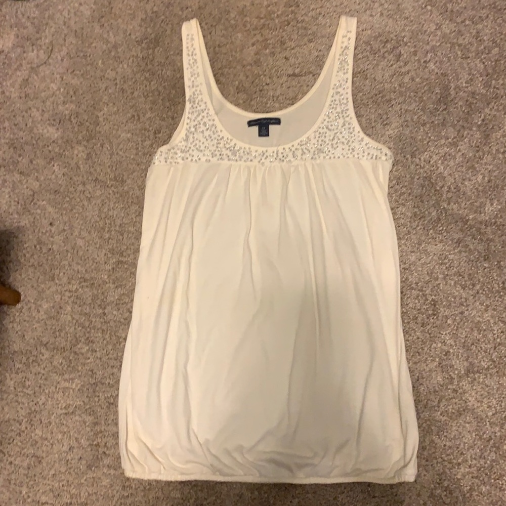 American Eagle White tank top, silver beads at top of shirt. Size Small